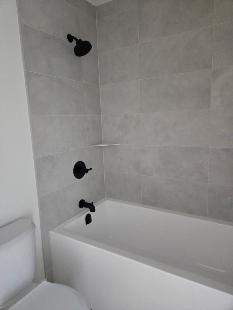 Shower wall with marble-look Zero Bianca 24x48 tiles in White Rock bathroom remodel