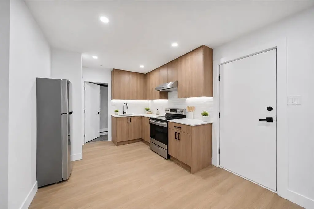 One of our recent kitchen renovation projects featuring light wood-look luxury vinyl plank flooring, chosen for its waterproof performance and low-maintenance finish.