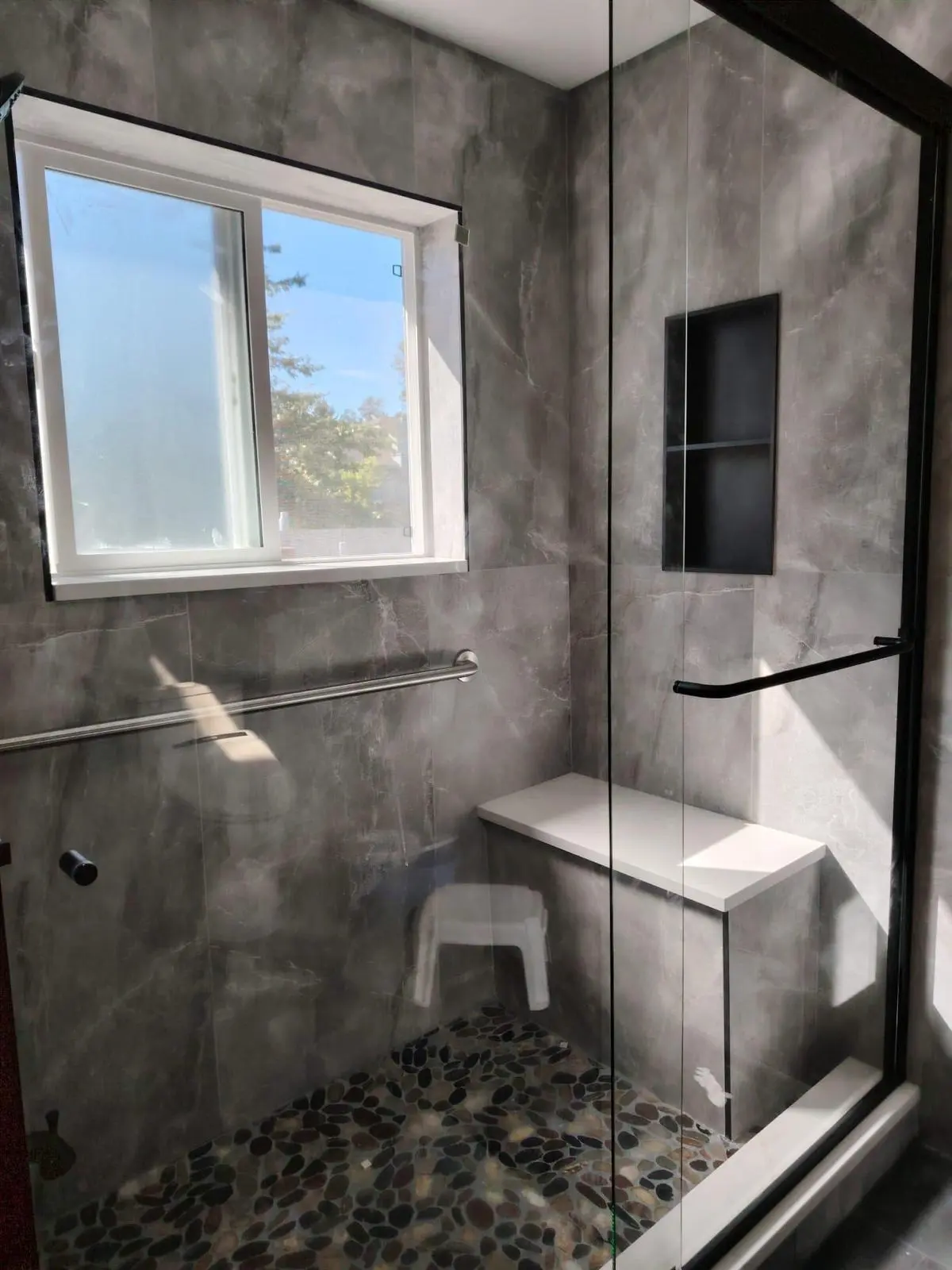 Bathroom renovation in Kerrisdale with custom walk-in shower and pebble tile floor